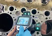 Handheld 3D scanner measuring an engine block