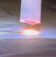 Pulse laser welding torch in operation, comparison test with laser cladding